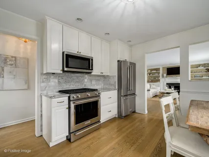 a kitchen with stainless steel appliances a stove a refrigerator and a microwave