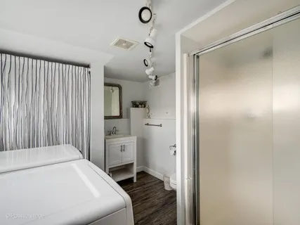 a hallway with cabinets and wooden floor