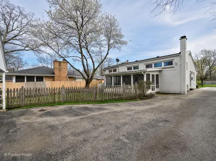 a view of a house with a small yard and plants