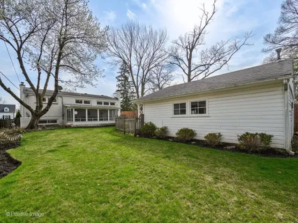 a view of a house with a backyard