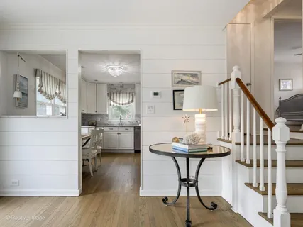 a dining room with furniture and wooden floor