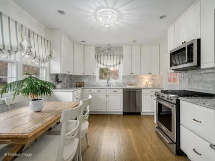 a kitchen with a white cabinets and stainless steel appliances