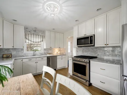 a kitchen with a white cabinets and appliances