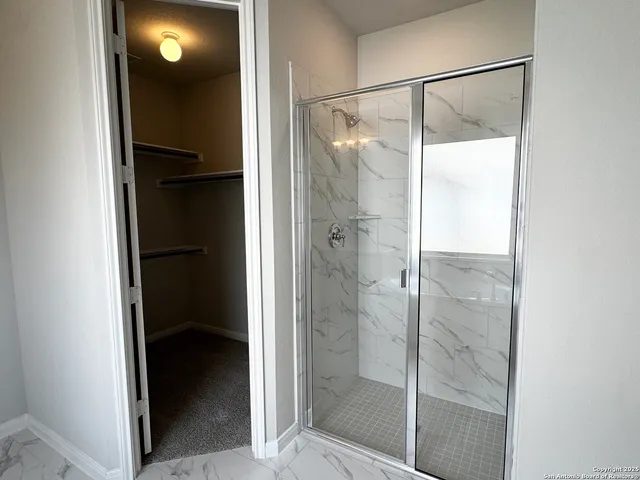a bathroom with a glass shower door