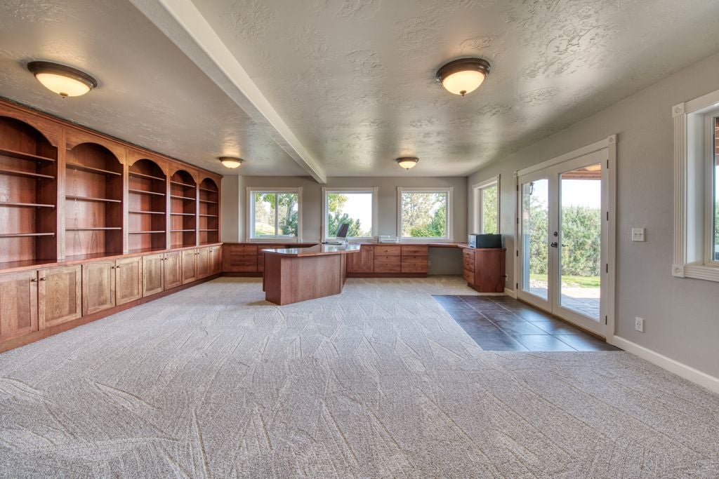 16374 Folsom Road Florence, MT 59833 - Photo 86 of 98 Unfurnished office with light carpet, a textured ceiling, beam ceiling, and french doors