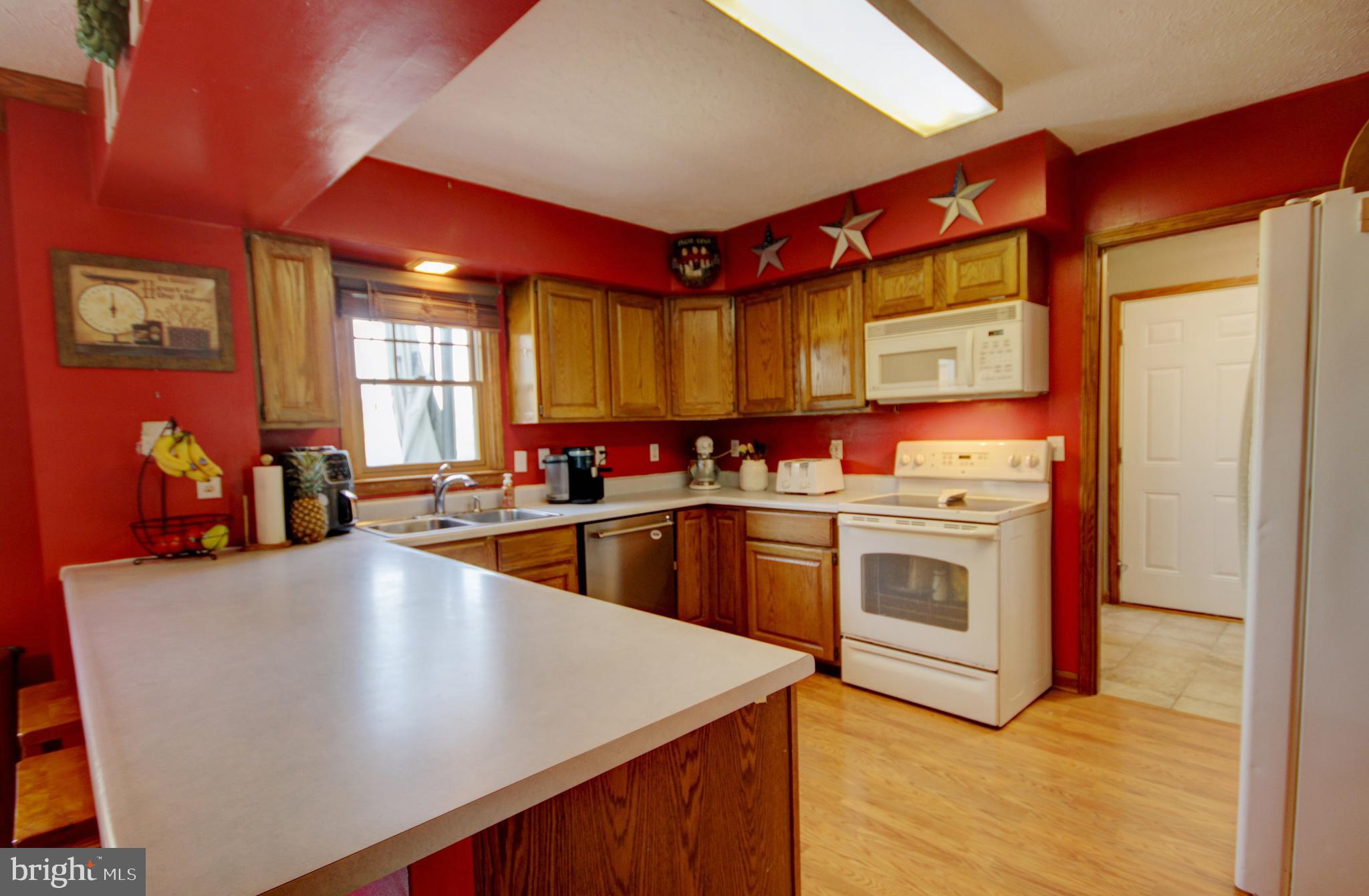 215 Hoffecker Road Phoenixville, PA 19460 - Photo 12 of 49 a large kitchen with stainless steel appliances granite countertop a stove a sink and a refrigerator
