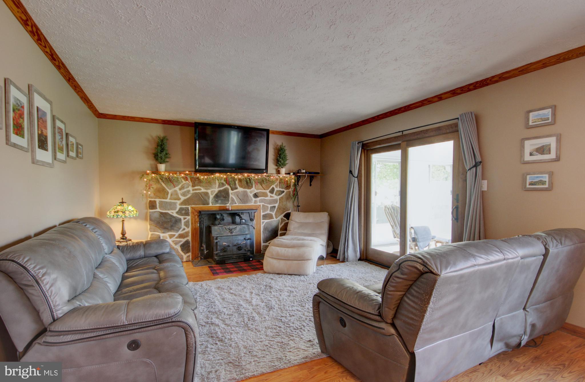 215 Hoffecker Road Phoenixville, PA 19460 - Photo 19 of 49 a living room with fireplace furniture and a flat screen tv