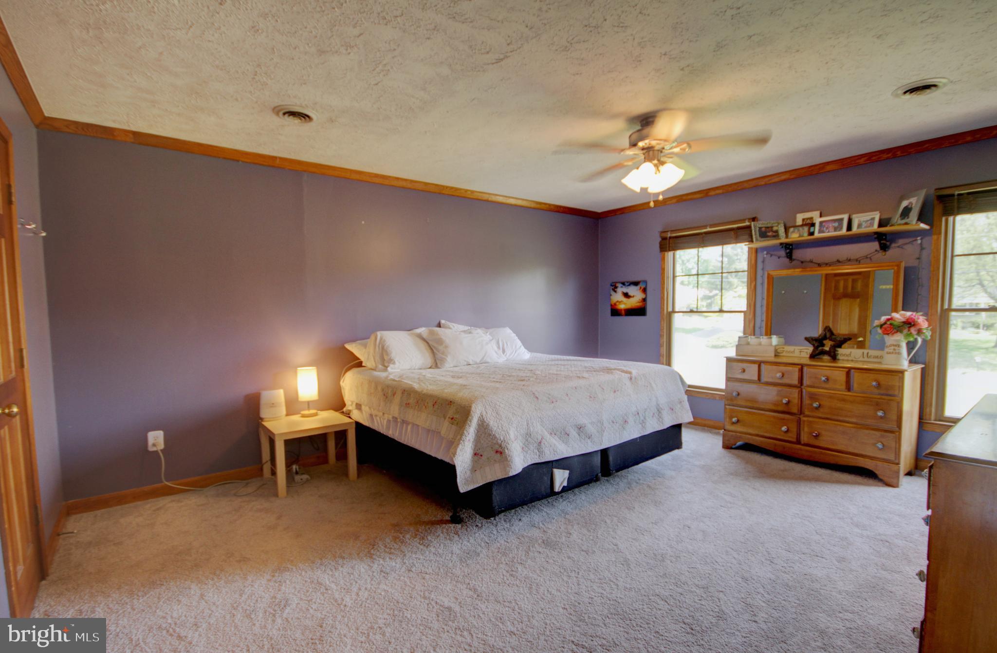 215 Hoffecker Road Phoenixville, PA 19460 - Photo 31 of 49 a bedroom with a bed a chandelier and dresser