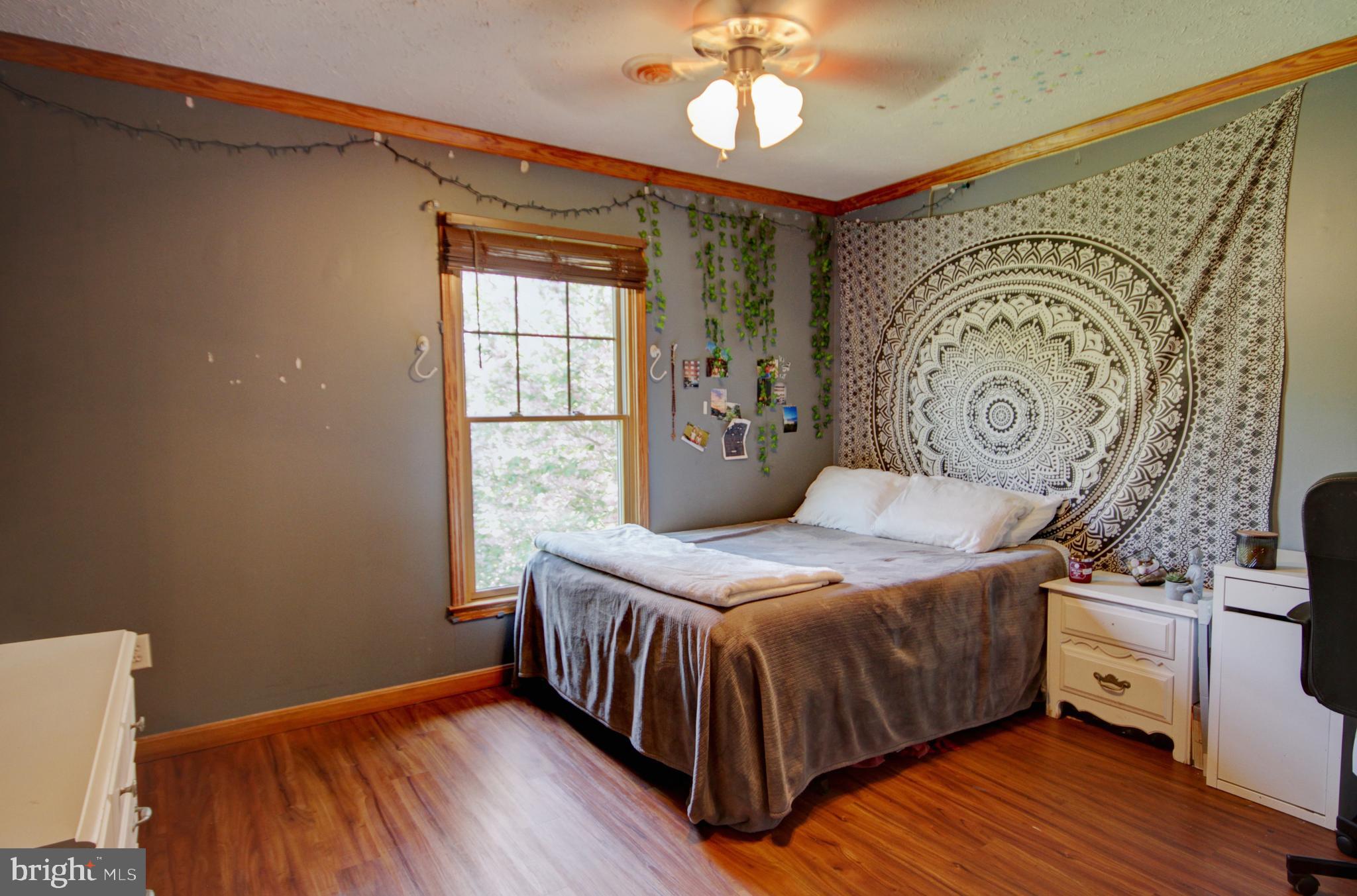 215 Hoffecker Road Phoenixville, PA 19460 - Photo 37 of 49 a bedroom with a bed and wooden floor