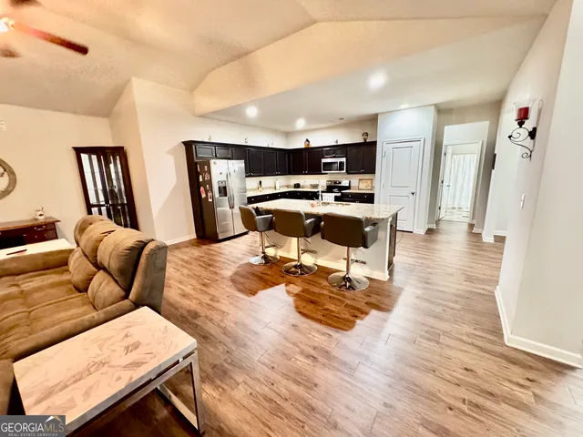 a kitchen with a sink a stove a refrigerator and cabinets