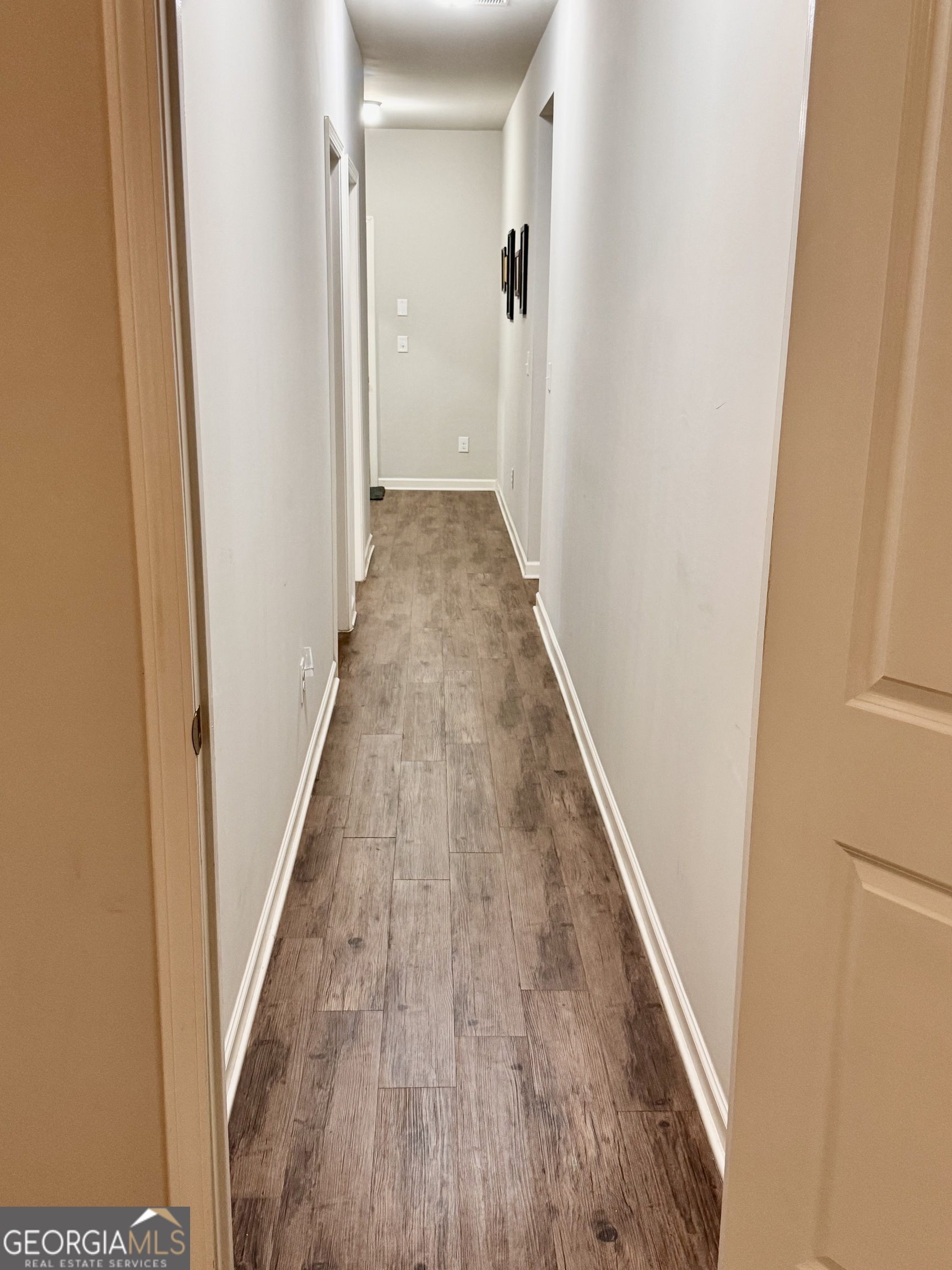 52 Pulaski Avenue Hampton, GA 30228 - Photo 15 of 32 a view of a hallway with wooden floor and staircase
