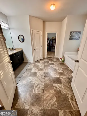 a large kitchen with stainless steel appliances kitchen island granite countertop a large counter top and view of living room