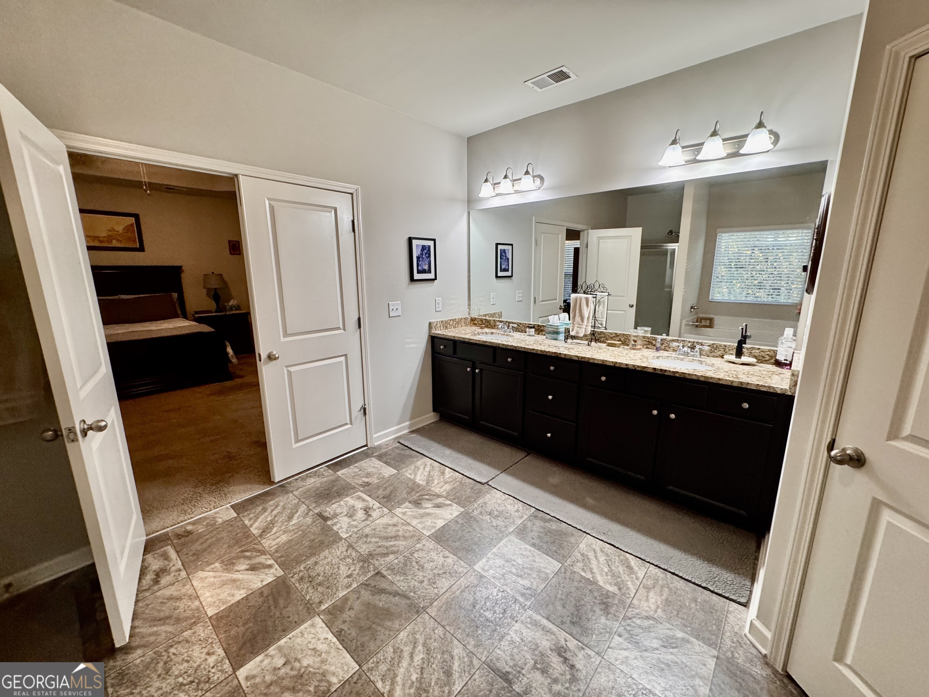 52 Pulaski Avenue Hampton, GA 30228 - Photo 27 of 32 a spacious bathroom with a sink and a mirror