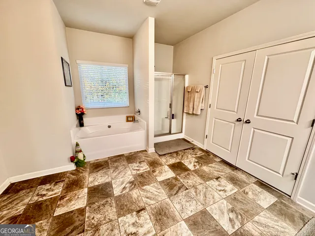 a backyard of a house with large trees and wooden fence