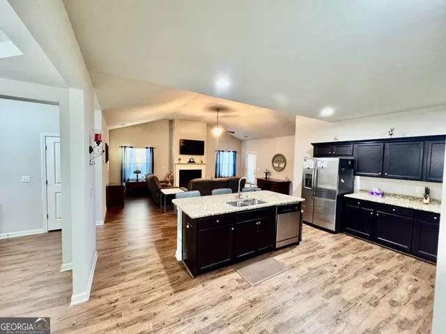 a view of a backyard with wooden fence