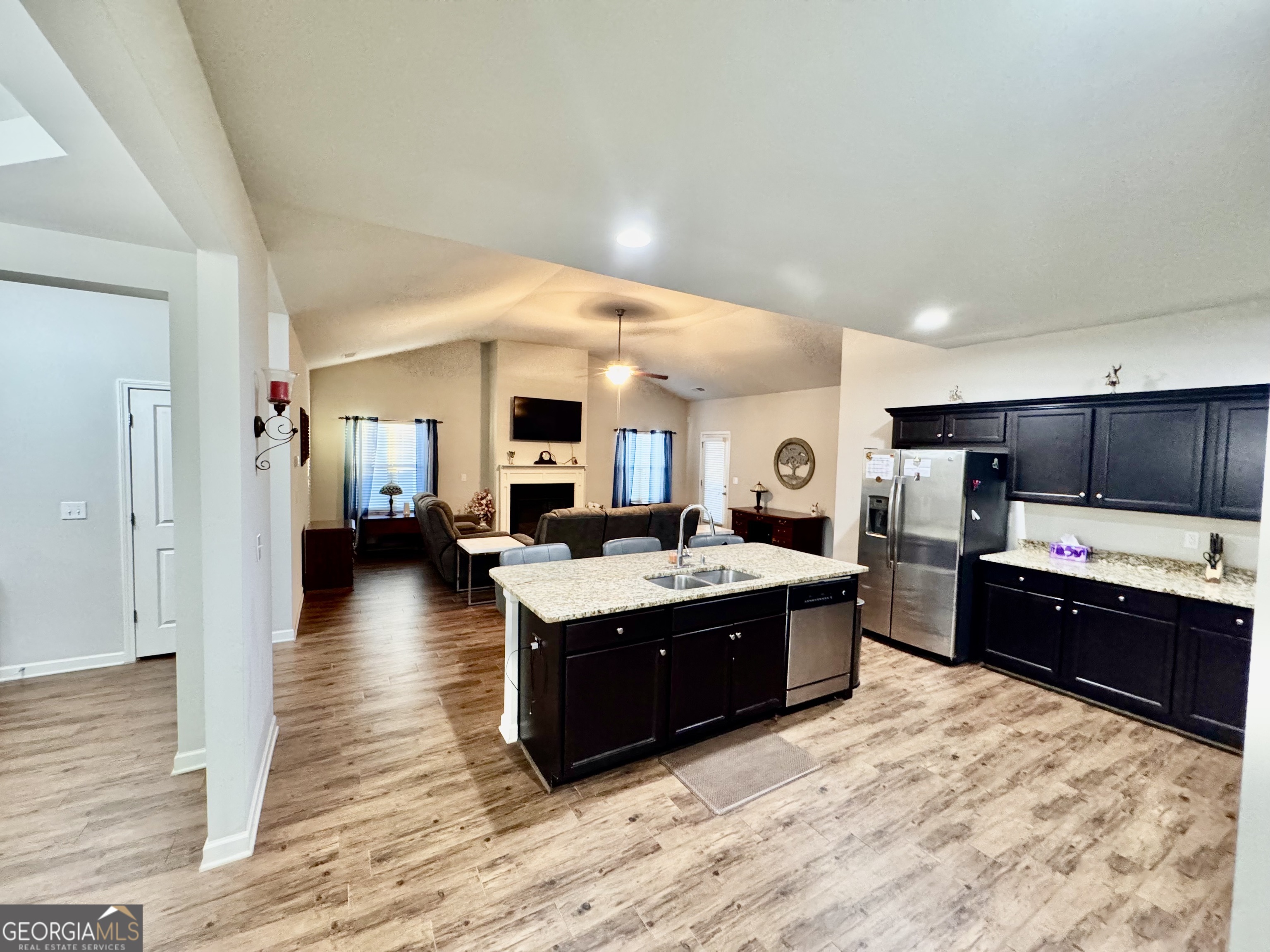52 Pulaski Avenue Hampton, GA 30228 - Photo 29 of 32 a large kitchen with stainless steel appliances kitchen island granite countertop a large counter top and view of living room