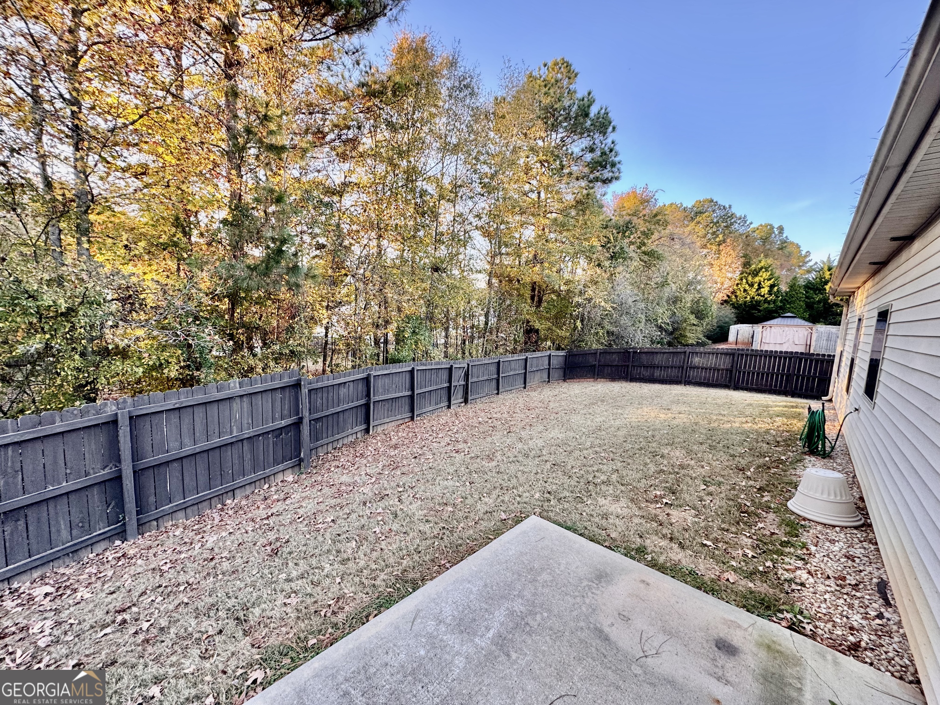 52 Pulaski Avenue Hampton, GA 30228 - Photo 32 of 32 a view of a backyard with wooden fence
