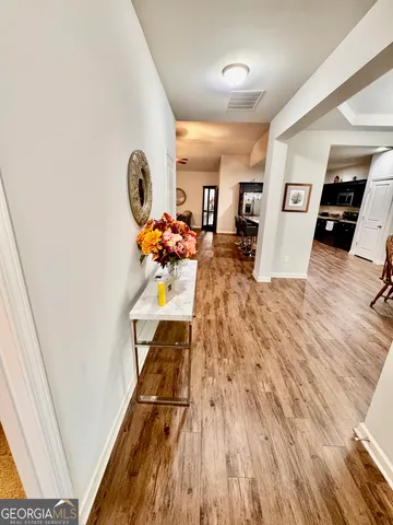 a living room with furniture and a wooden floor