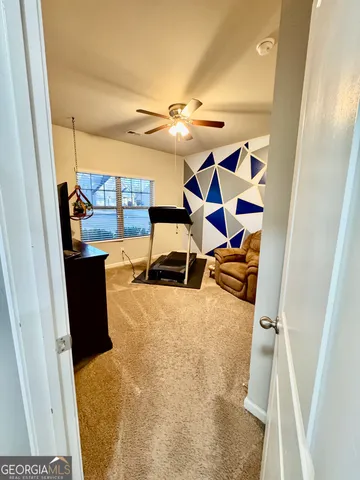 a view of a living room with furniture and a rug