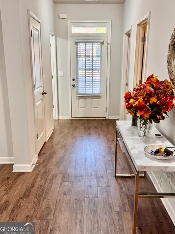 a view of a livingroom with a chandelier furniture and windows