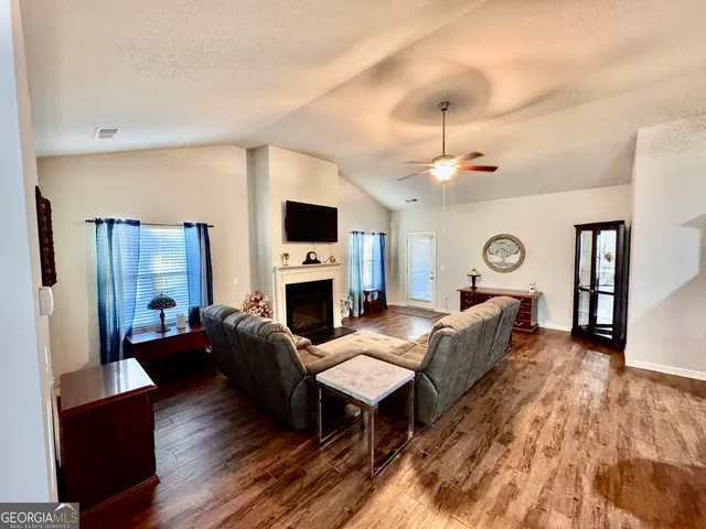 a living room with furniture fireplace and flat screen tv