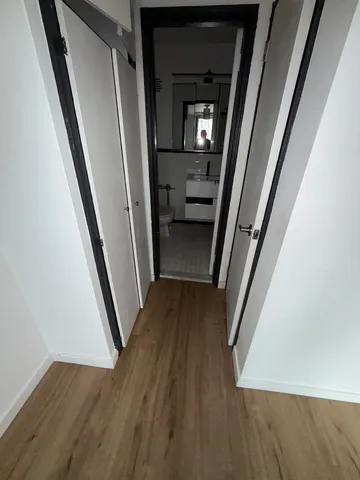 a view of a hallway view with wooden floor and staircase