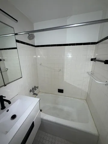 a bathroom with a tub and a shower