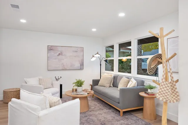 a bedroom with a bed and a painting on the wall