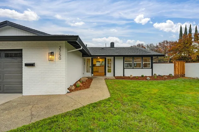 a view of a house with backyard and garden
