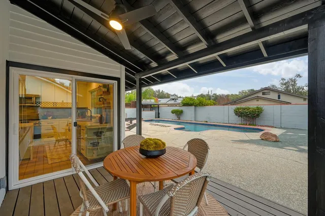 a view of a house with backyard and sitting area