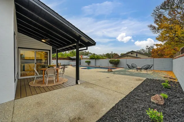 a view of a swimming pool with an outdoor seating