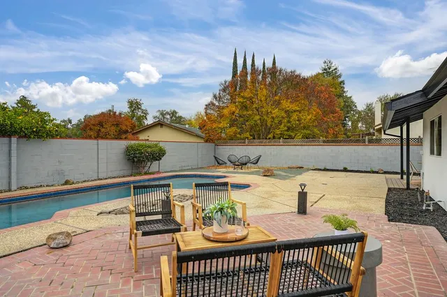 swimming pool view with a outdoor seating