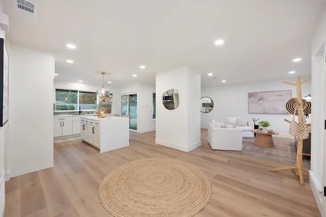 a living room with furniture and a wooden floor