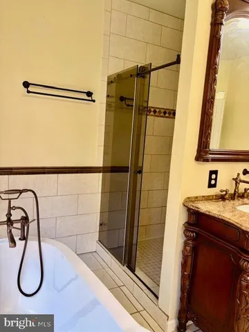 a bathroom with a granite countertop sink a large mirror and a window