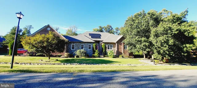 a view of a living room with hardwood floor and large windows