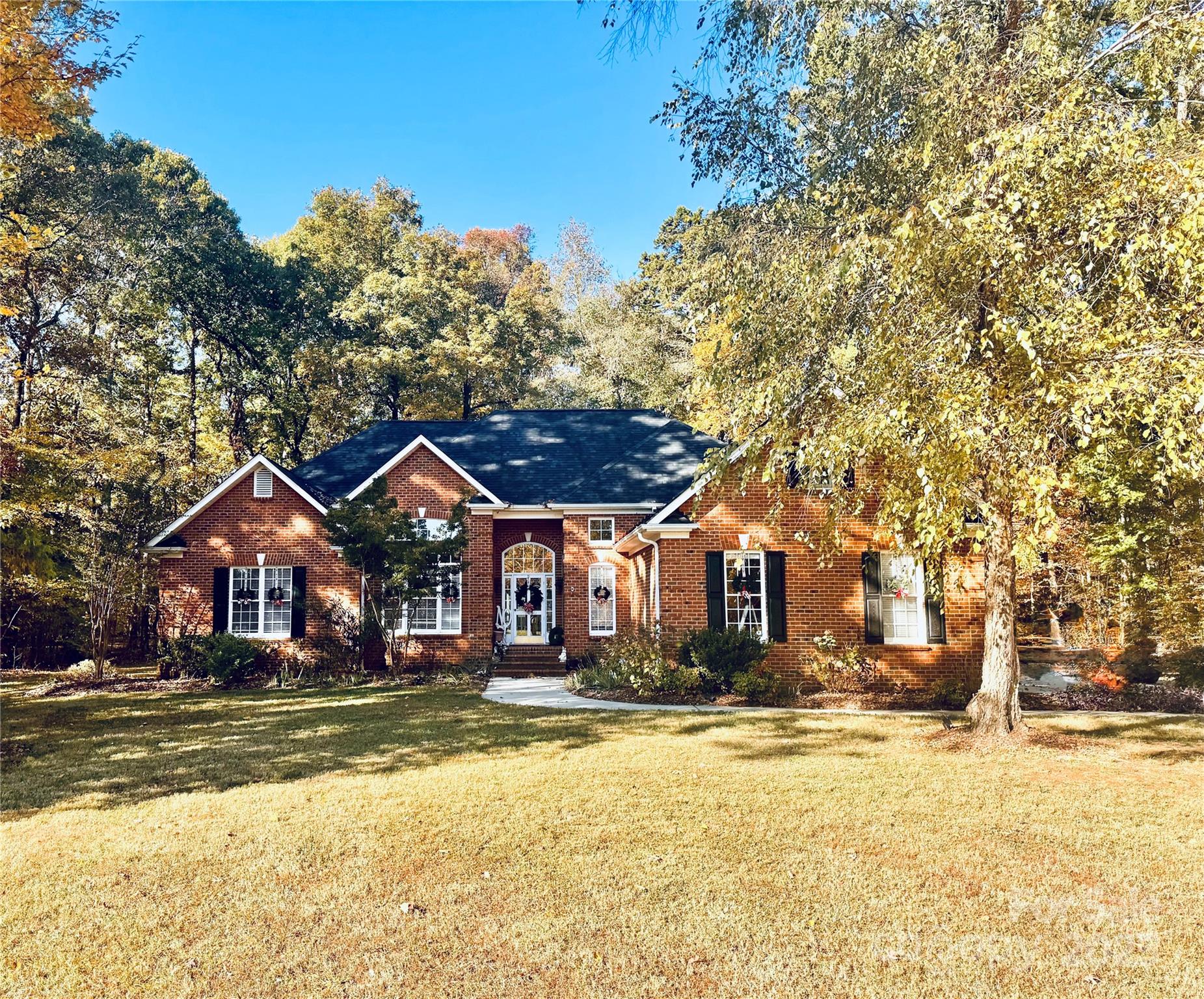 a view of large house with a large tree in front of it