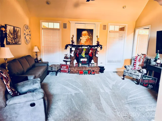 a kitchen with granite countertop a white stove top oven sink and cabinets