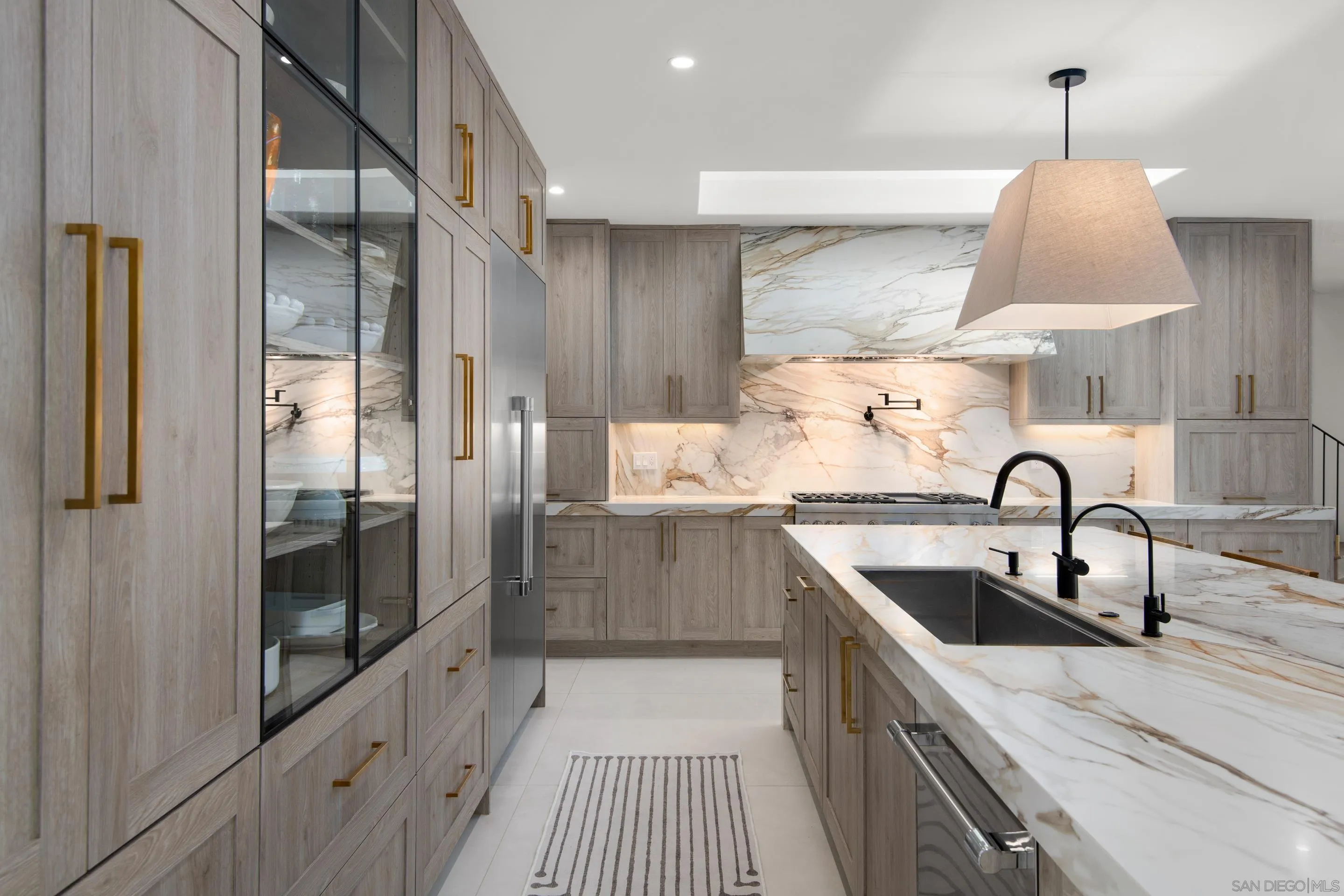 6665 Via Estrada La Jolla, CA 92037 - Photo 16 of 59 a kitchen with stainless steel appliances a sink a stove and a refrigerator