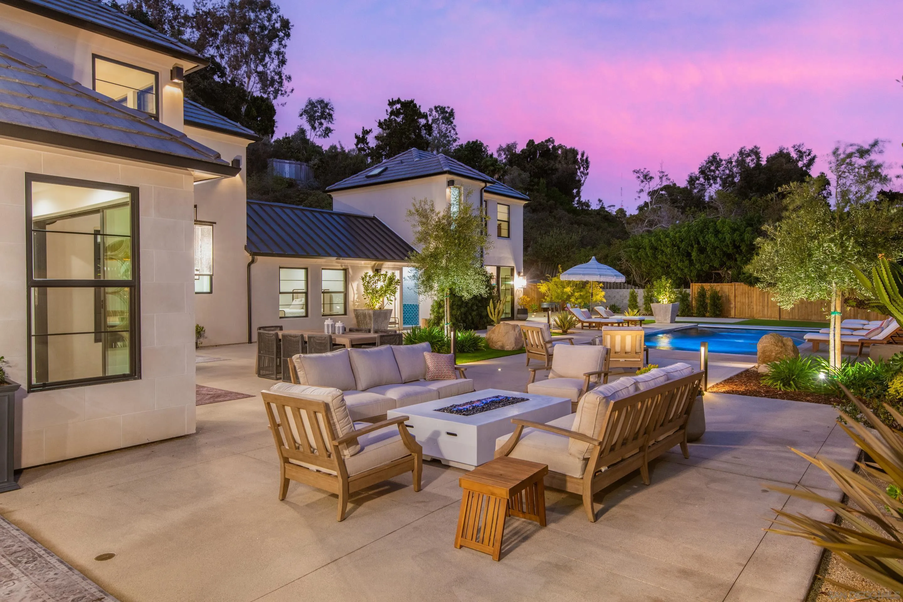 6665 Via Estrada La Jolla, CA 92037 - Photo 22 of 59 a view of a patio with couches and table and chairs and potted plants