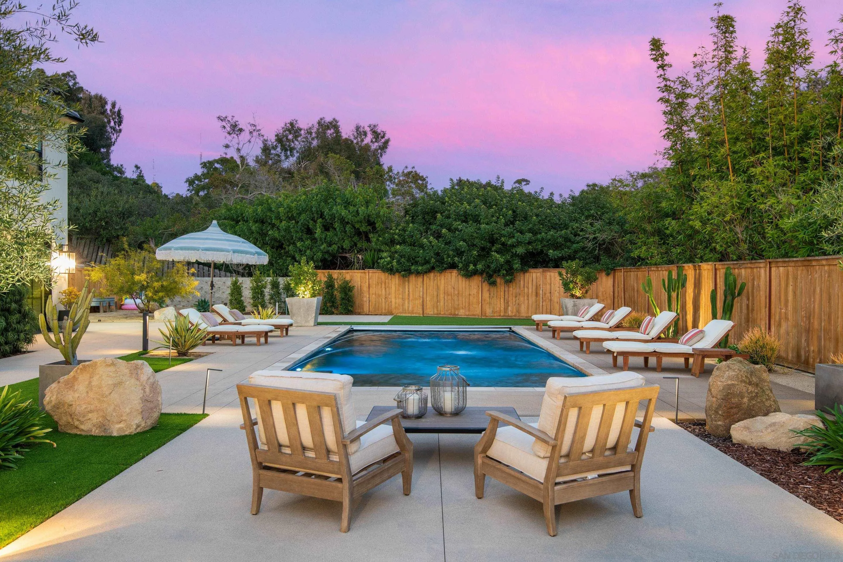 6665 Via Estrada La Jolla, CA 92037 - Photo 23 of 59 a patio with tables and chairs pool and fire pit