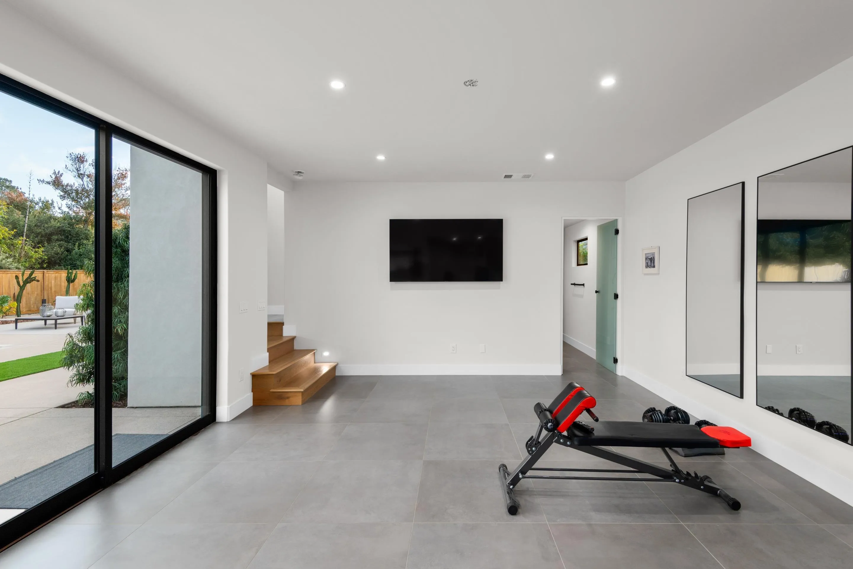 6665 Via Estrada La Jolla, CA 92037 - Photo 28 of 59 a living room with furniture and a flat screen tv