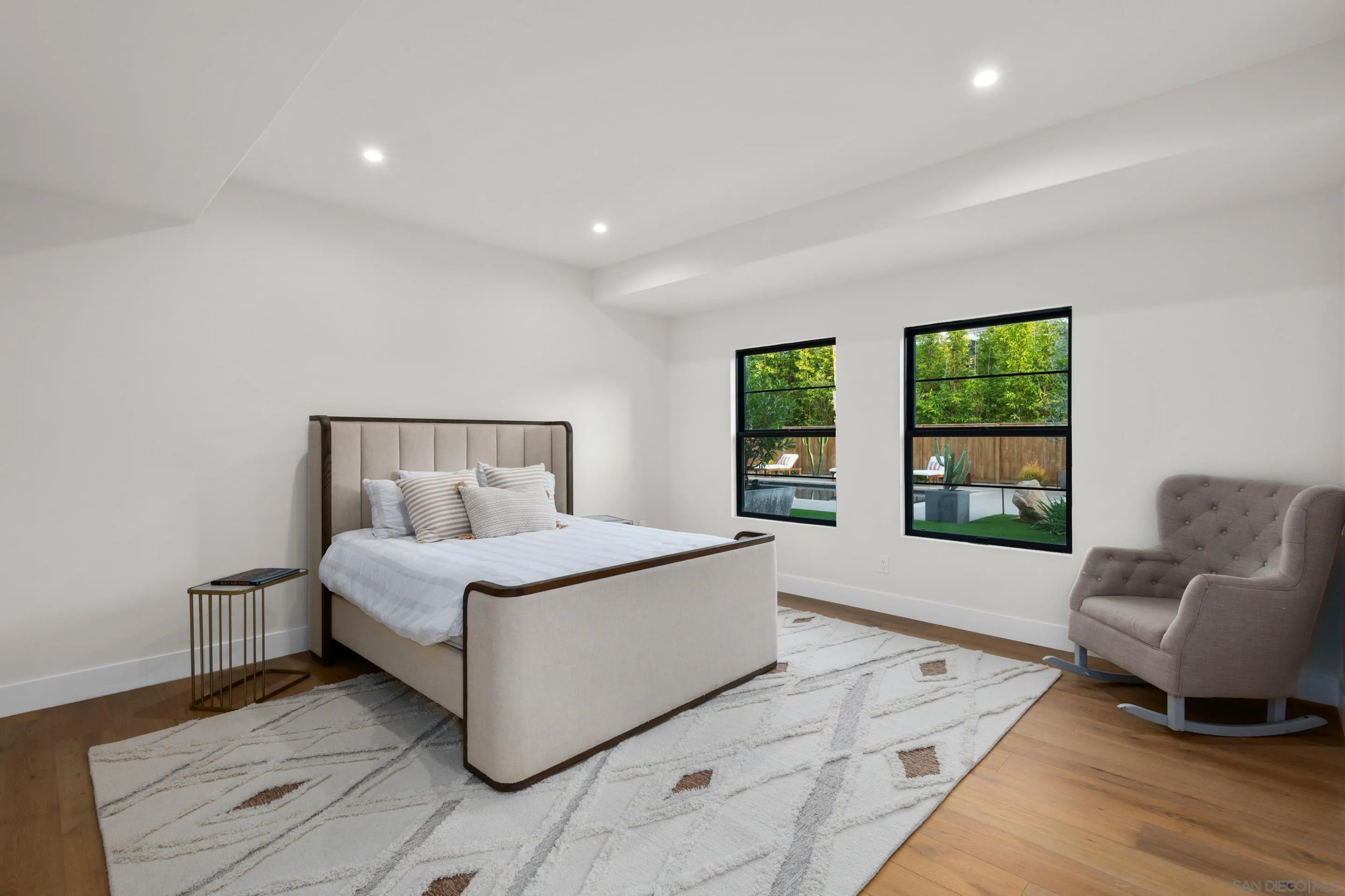 6665 Via Estrada La Jolla, CA 92037 - Photo 29 of 59 a bedroom with a large bed and a couch