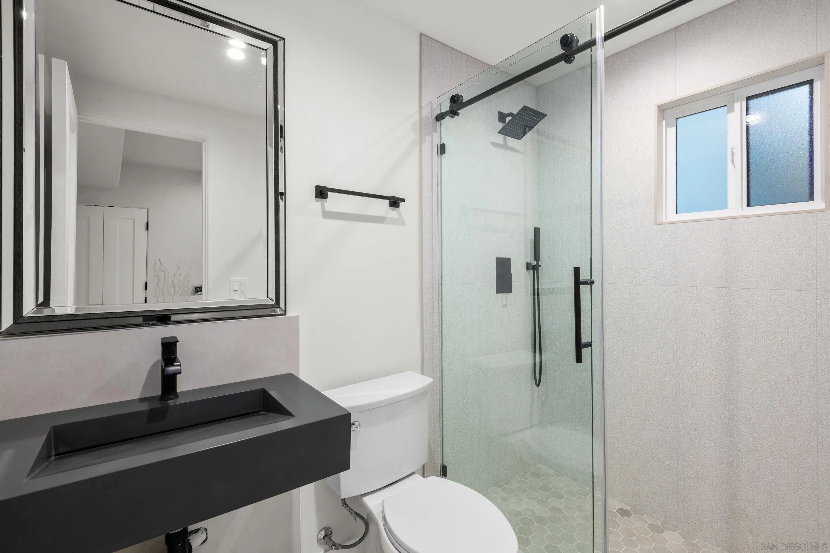 6665 Via Estrada La Jolla, CA 92037 - Photo 36 of 59 a bathroom with a sink a toilet and shower