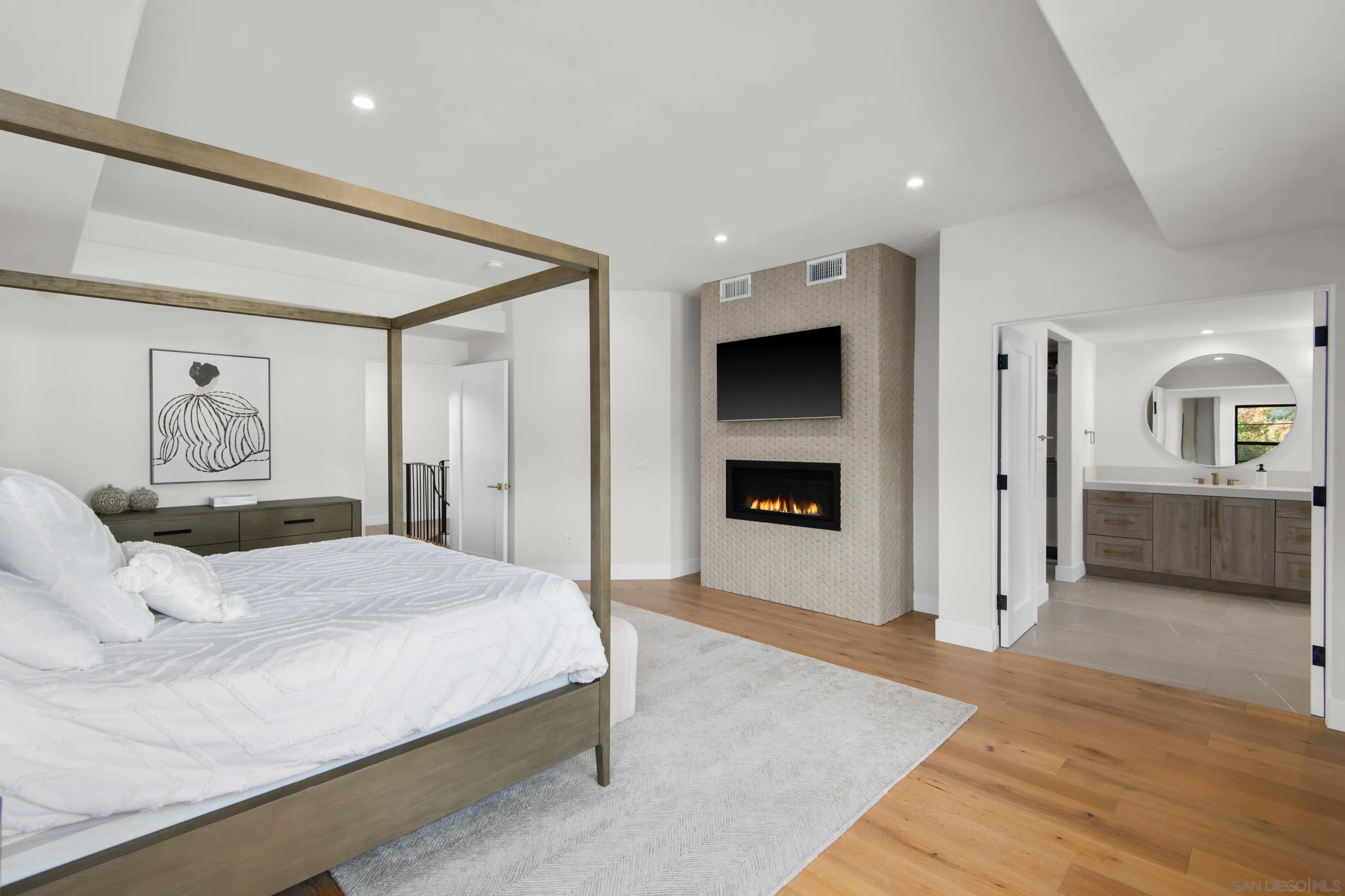 6665 Via Estrada La Jolla, CA 92037 - Photo 40 of 59 a spacious bedroom with a bed and a couch