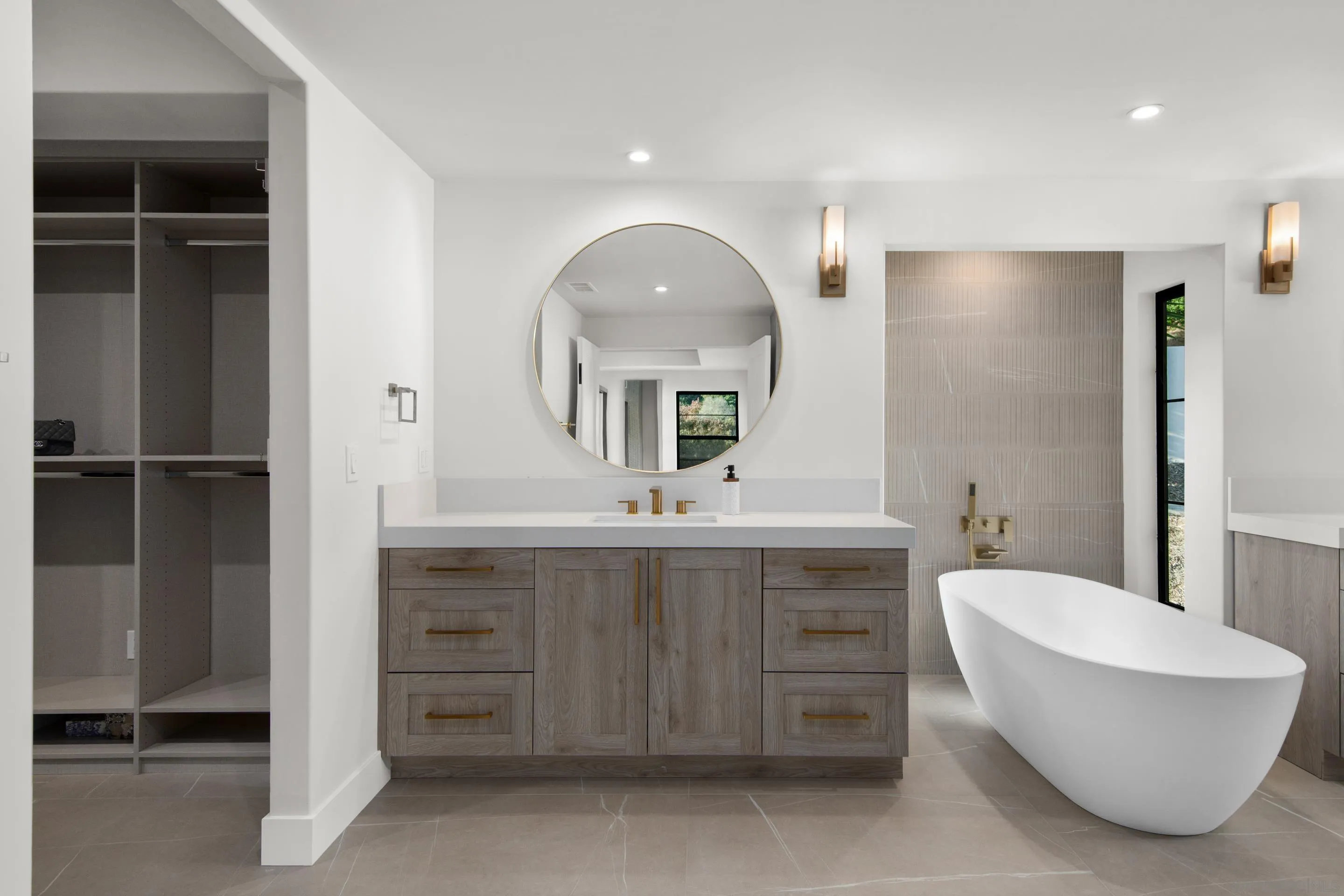 6665 Via Estrada La Jolla, CA 92037 - Photo 41 of 59 a spacious bathroom with a double vanity sink a mirror and a bathtub