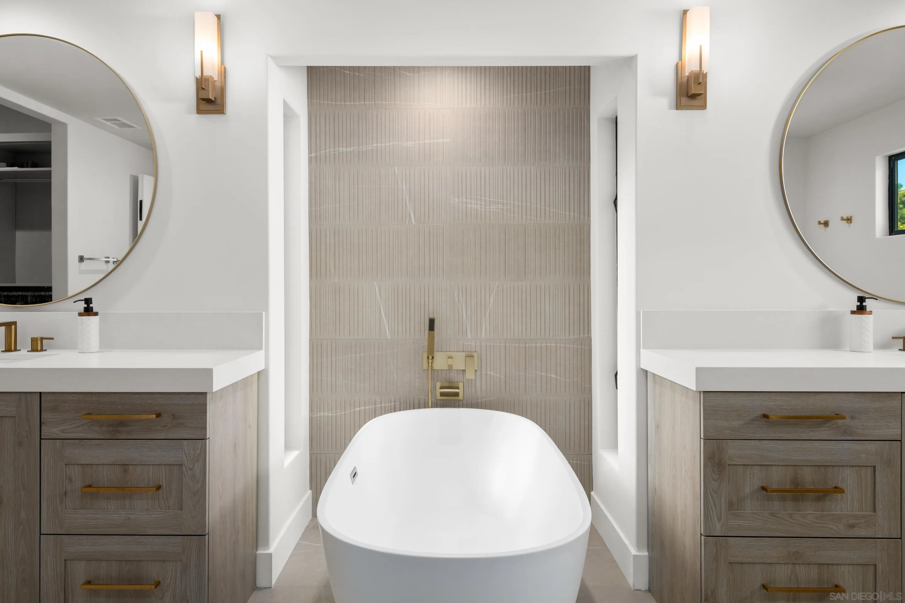 6665 Via Estrada La Jolla, CA 92037 - Photo 43 of 59 a bathroom with a sink a mirror a vanity and a shower