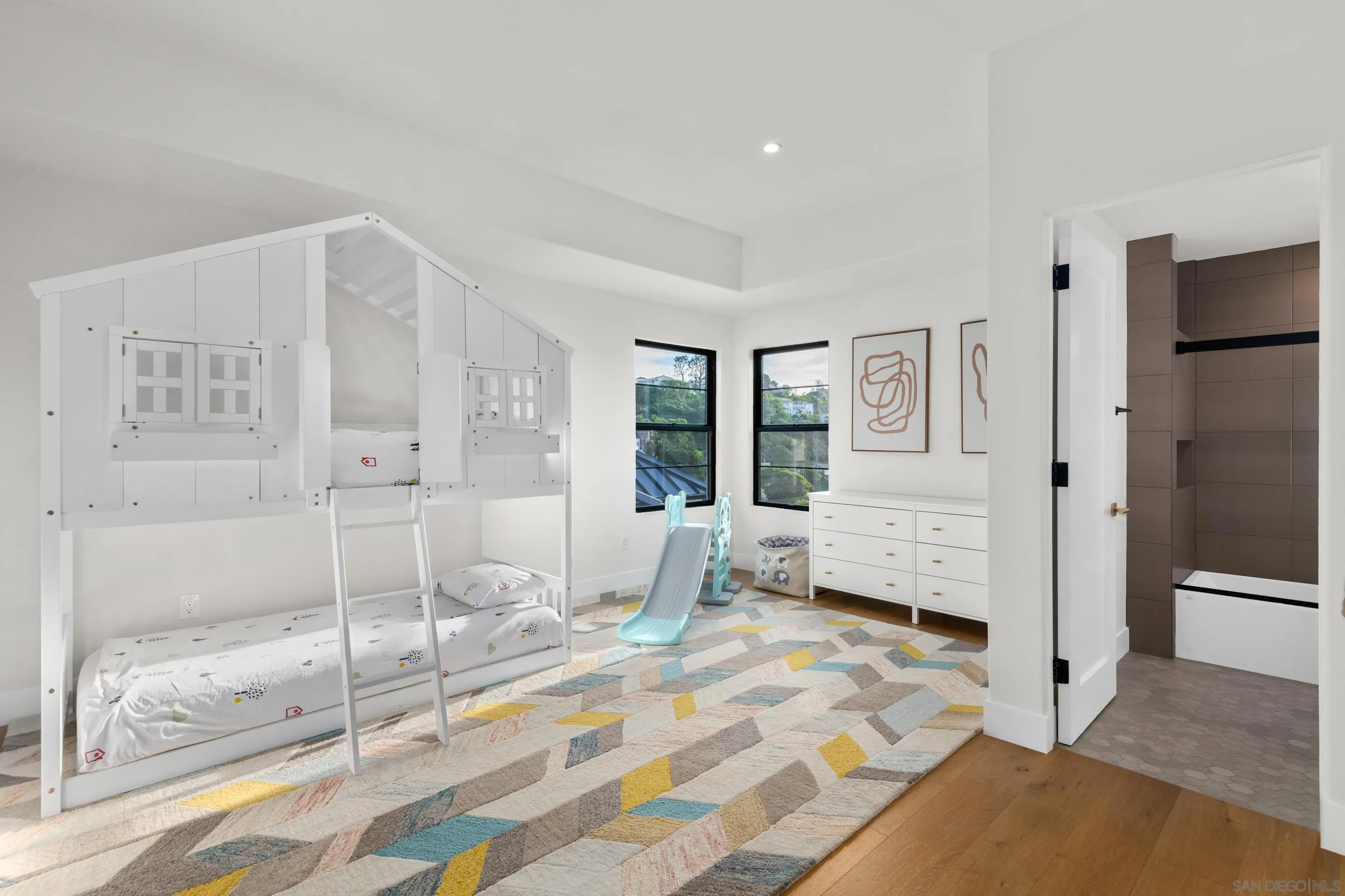 6665 Via Estrada La Jolla, CA 92037 - Photo 47 of 59 a bedroom with a bed and glass door