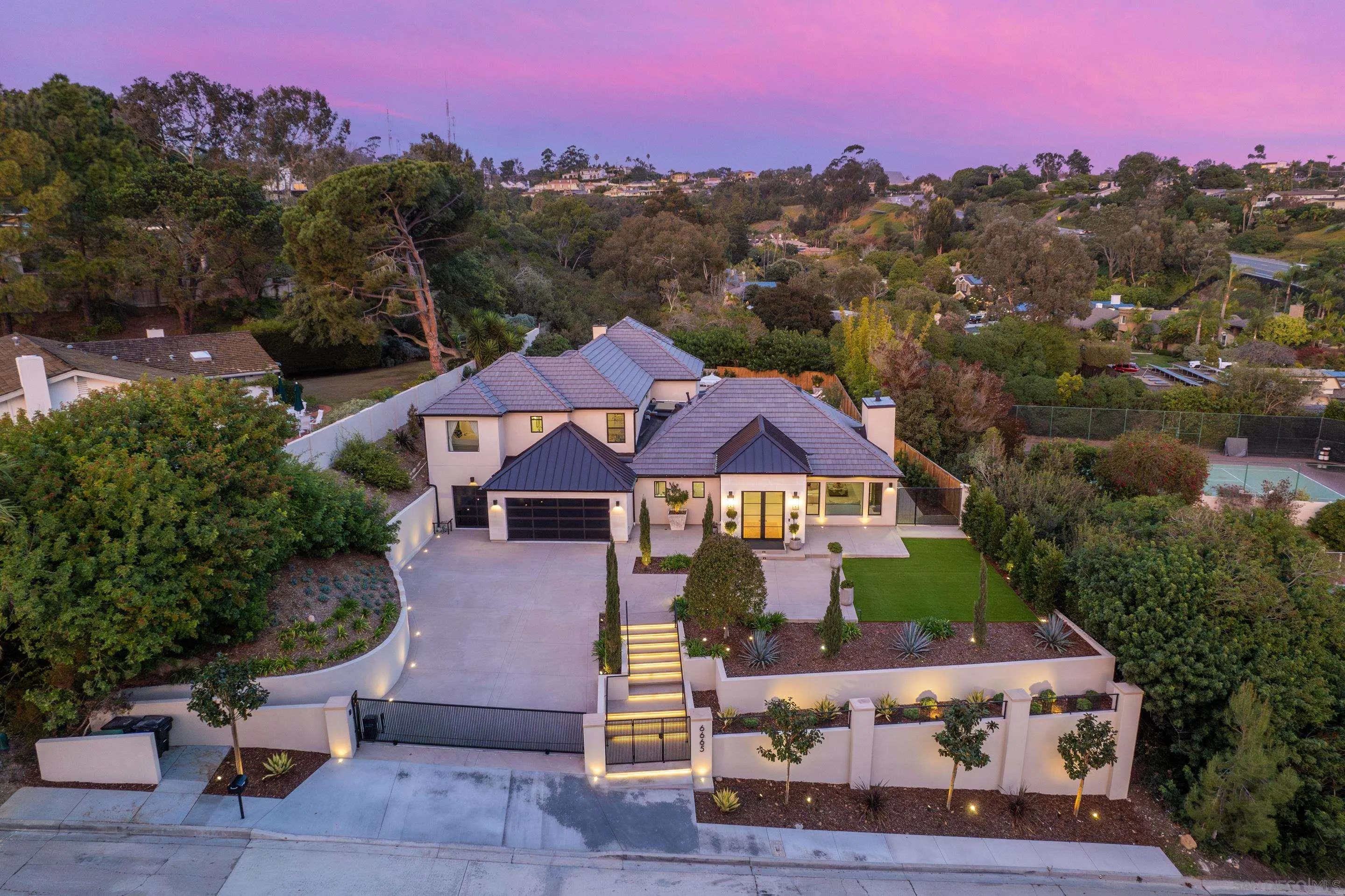 6665 Via Estrada La Jolla, CA 92037 - Photo 55 of 59 a front view of a house with a yard and mountain view in back