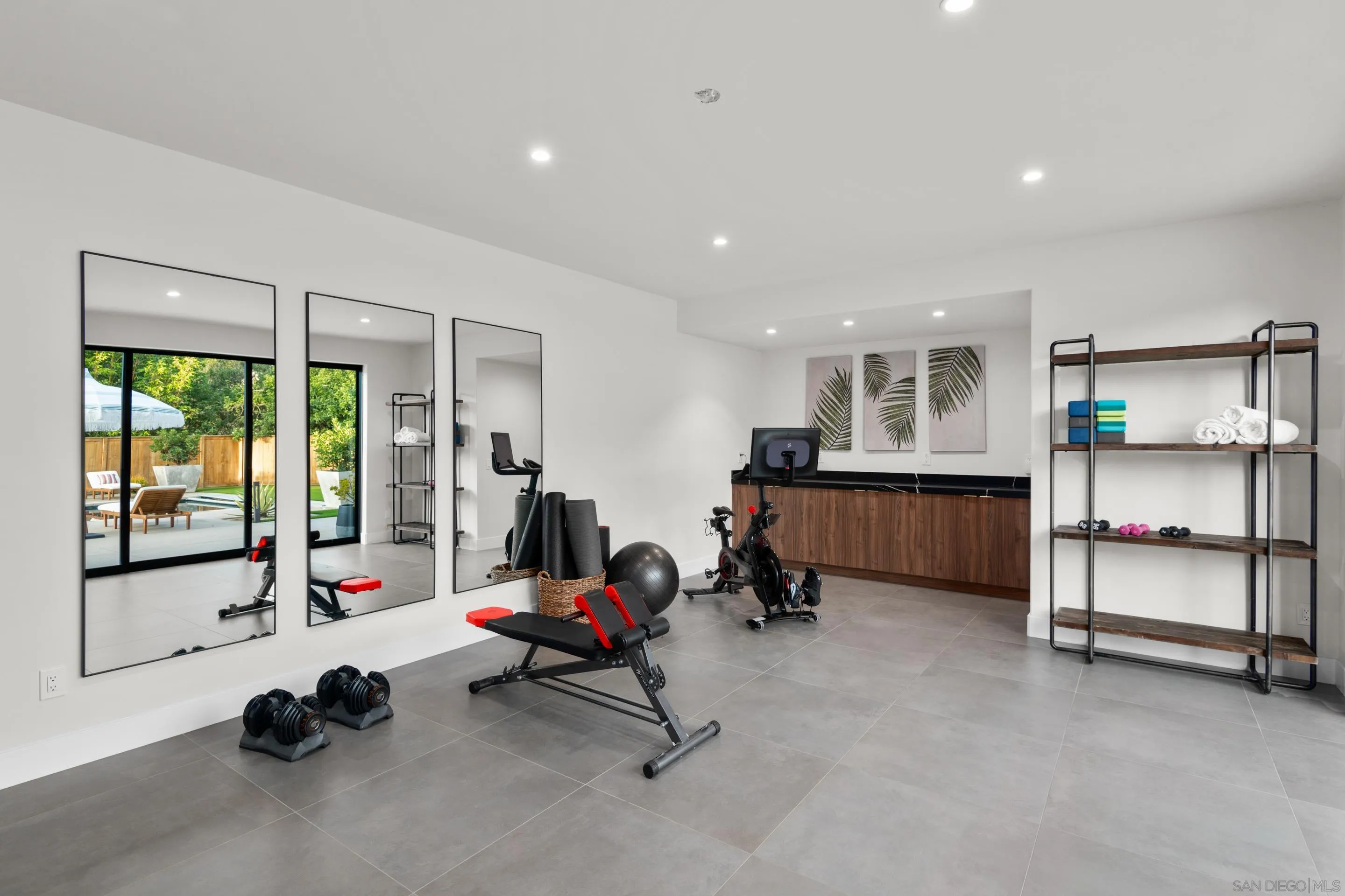 6665 Via Estrada La Jolla, CA 92037 - Photo 10 of 59 a living room with furniture gym equipment and a large window