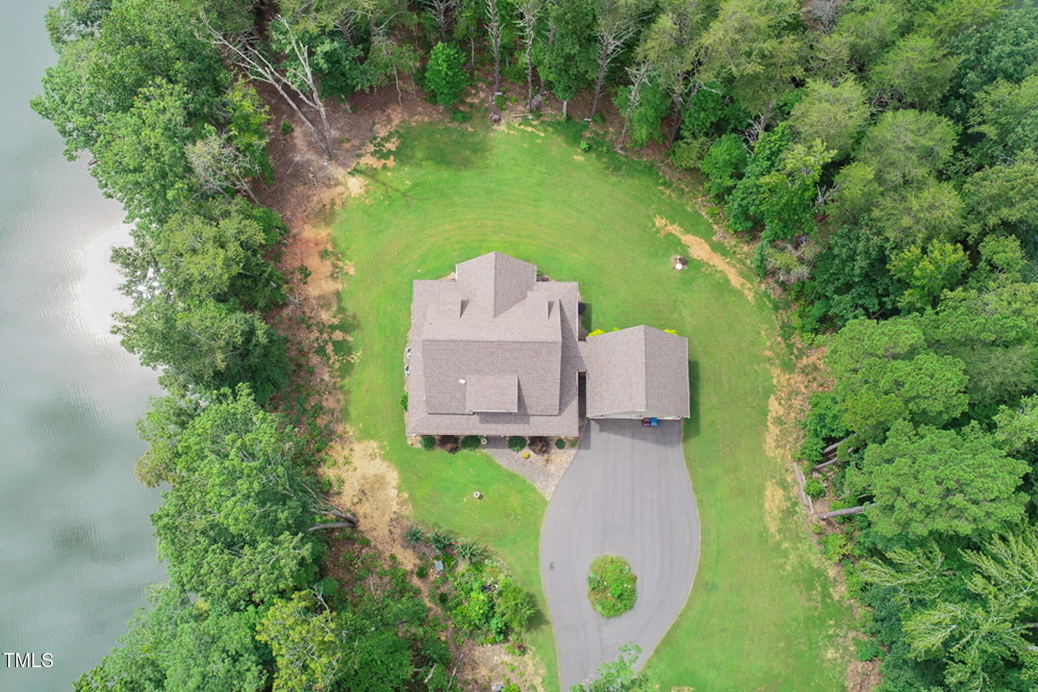 355 Fishermans Point Road Roxboro, NC 27574 - Photo 36 of 70 an aerial view of a house with outdoor space and trees all around